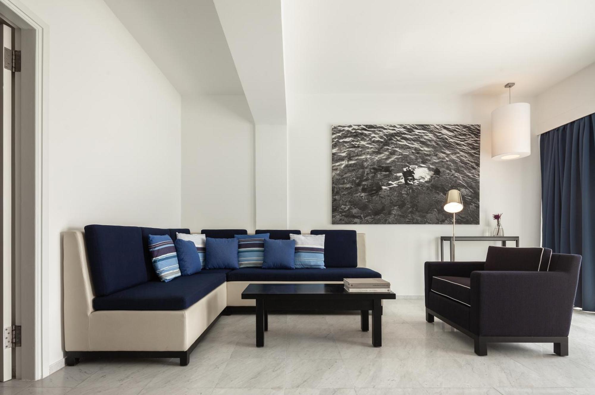 Almyra Hotel Paphos Kültér fotó A living room with a sectional sofa